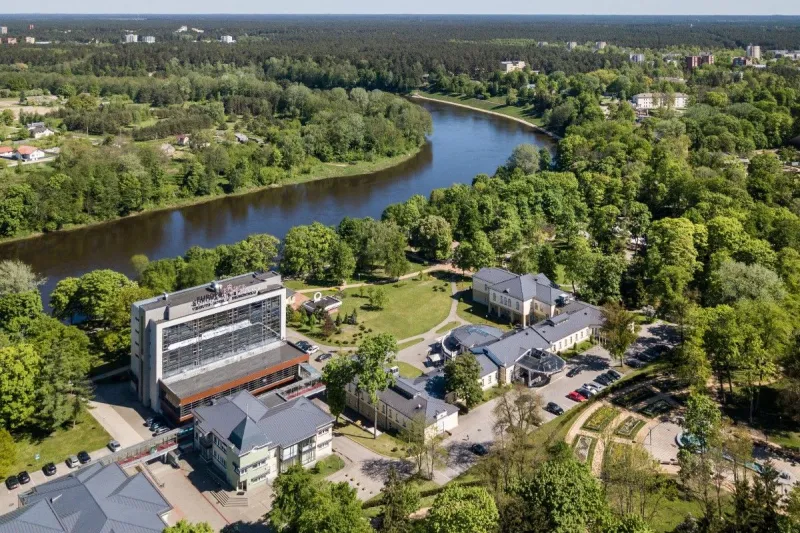 Aerial view of the hotel and river bend surrounded by forest