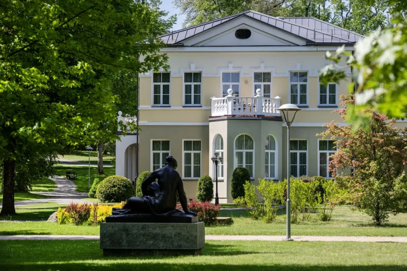Classical villa with a balcony among mature trees in Druskininkai town park