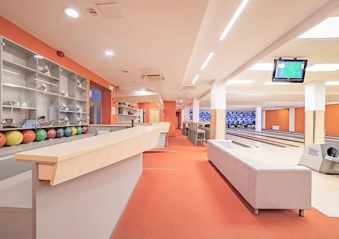 Bowling centre interior with the ball racks and service counter