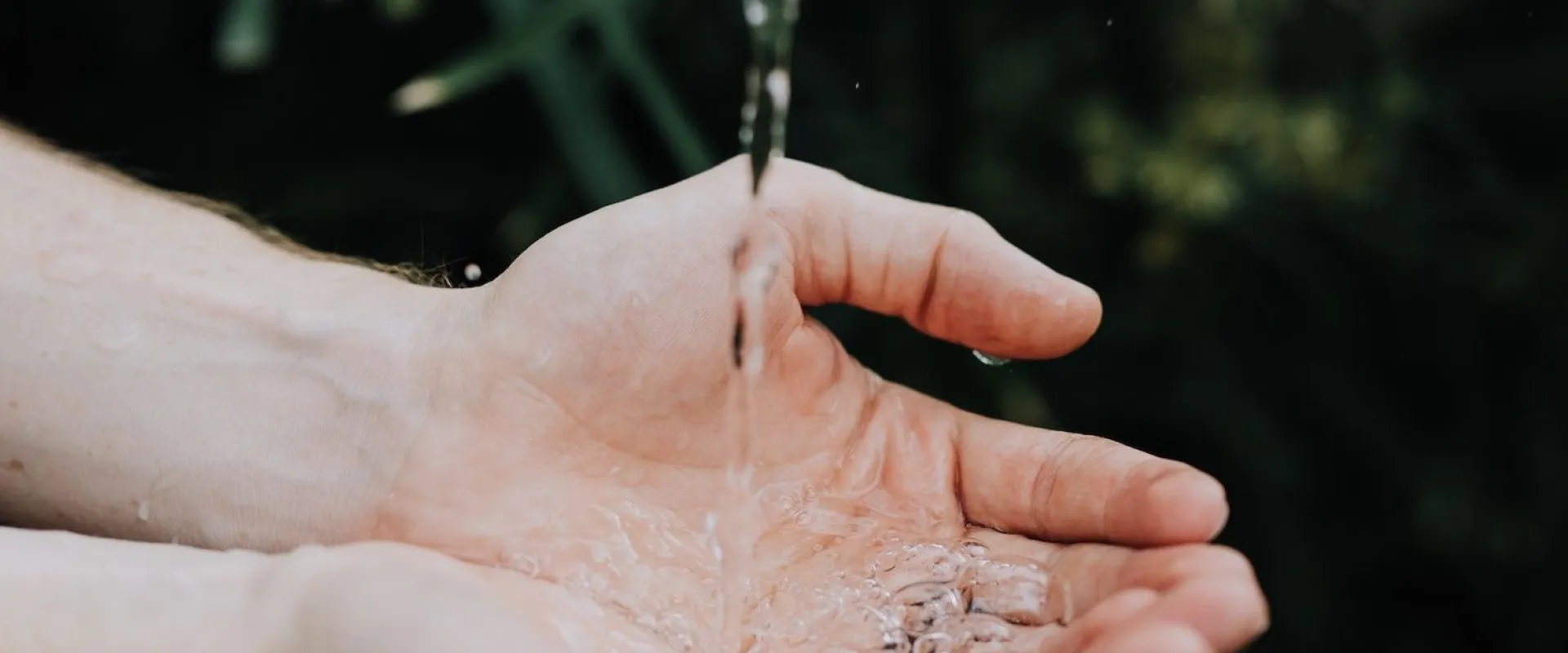 Spring water running over a pair of cupped hands