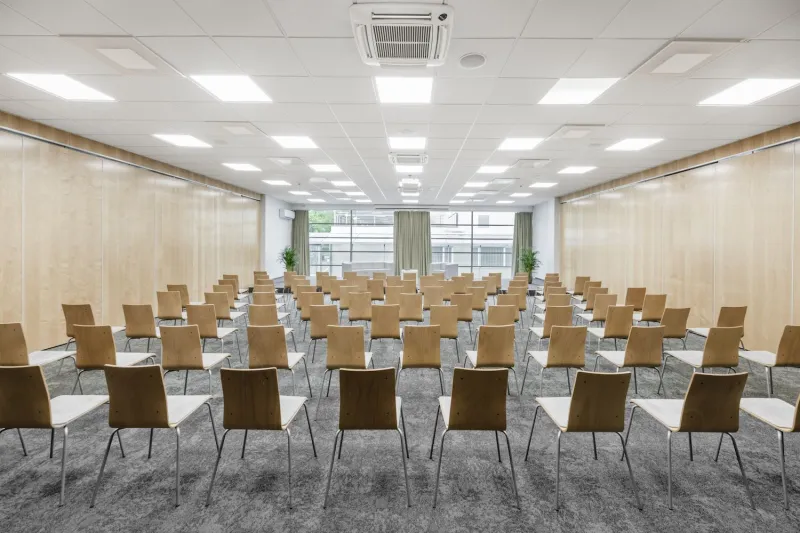 Conference room arranged theatre-style facing a window wall